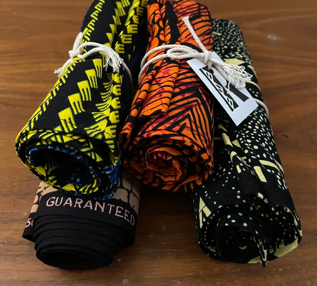 Rolled Roots print fabrics tied with string